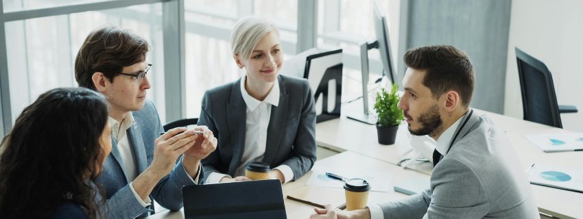 Finance team meeting around a desk